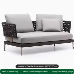 Close-up of woven rattan texture and aluminum frame on modular outdoor sofa set cushions.
