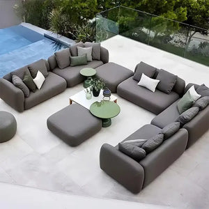 Modern gray outdoor patio sofa with waterproof cushions and fade resistant fabric detail