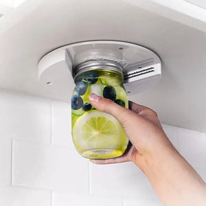Under cabinet mounted bottle and jar opener with easy grip handle in kitchen